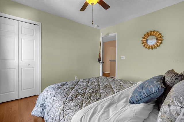 bedroom with a closet, ceiling fan, and light hardwood / wood-style flooring