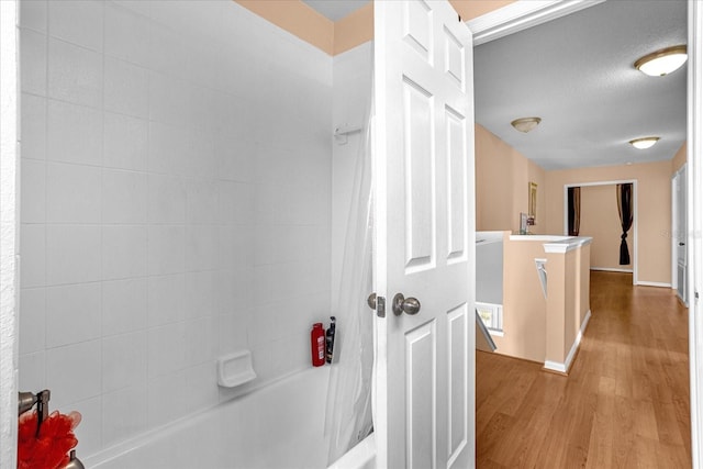 bathroom featuring shower / tub combo, vanity, a textured ceiling, and wood-type flooring