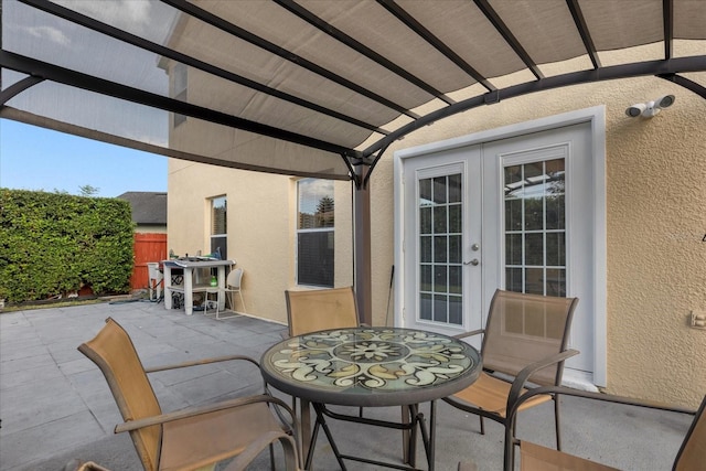 view of terrace featuring a pergola and french doors