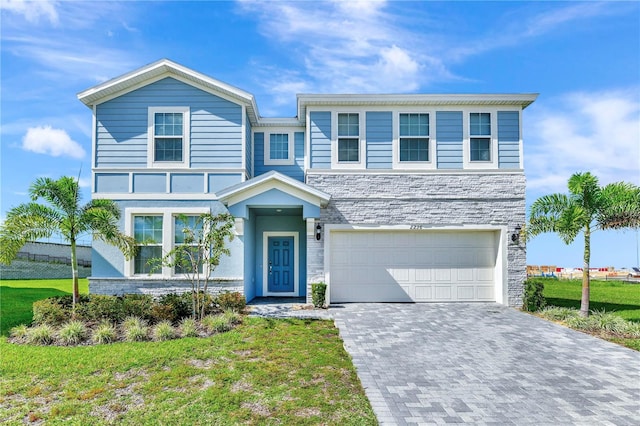 view of front of home with a front lawn and a garage