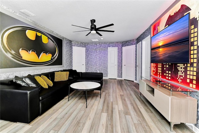 living room featuring ceiling fan and light wood-type flooring