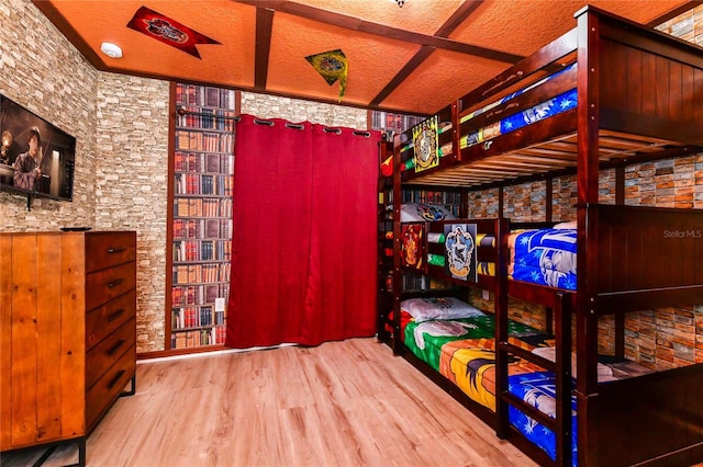 bedroom featuring a textured ceiling and light wood-type flooring