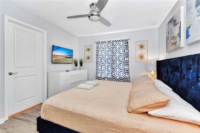 bedroom with ceiling fan and light hardwood / wood-style flooring