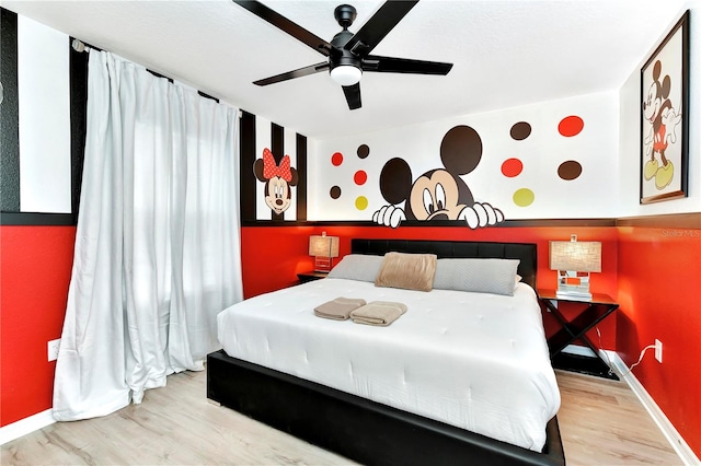 bedroom with ceiling fan and light hardwood / wood-style flooring