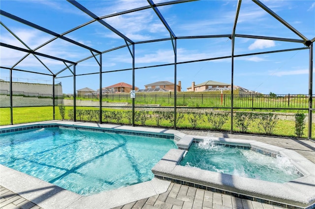 view of swimming pool with an in ground hot tub and a lanai