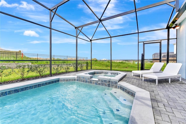 view of swimming pool featuring an in ground hot tub, glass enclosure, and a patio