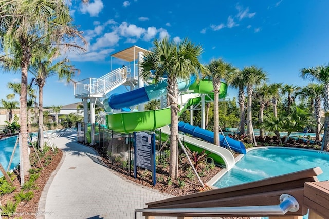 view of jungle gym featuring a community pool