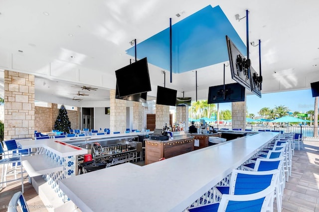 kitchen featuring a center island, ceiling fan, and a kitchen breakfast bar