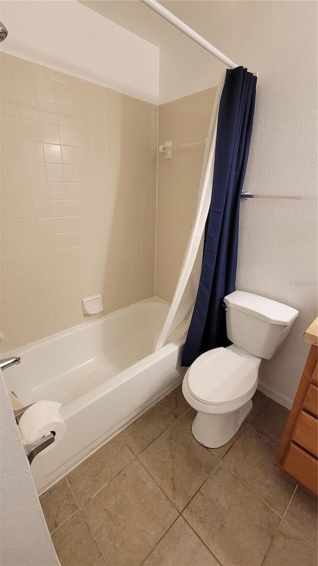 full bathroom featuring shower / bath combination with curtain, toilet, tile floors, and vanity