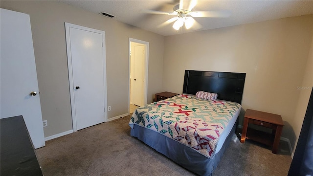 bedroom with dark colored carpet and ceiling fan