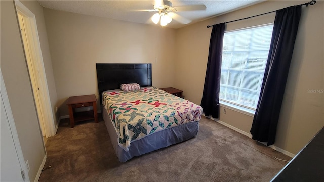 carpeted bedroom with a textured ceiling, multiple windows, and ceiling fan