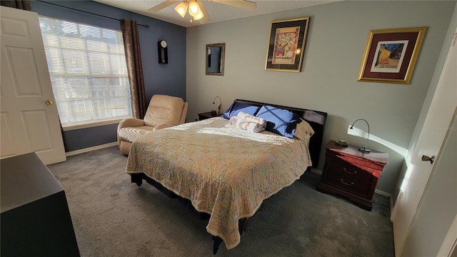 bedroom featuring ceiling fan and dark colored carpet