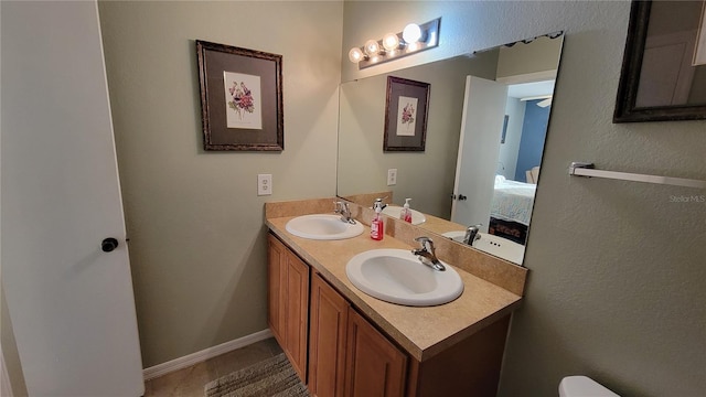 bathroom with dual bowl vanity and tile floors