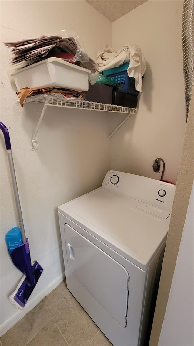 washroom with washer / clothes dryer and light tile flooring