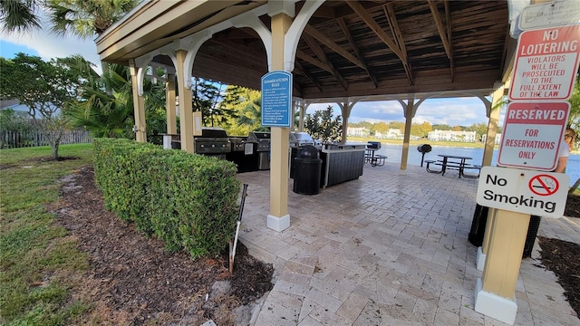 view of patio / terrace featuring a grill and a water view