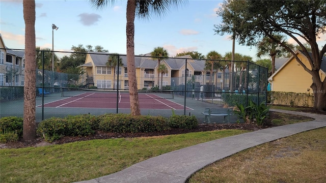 view of sport court with a lawn