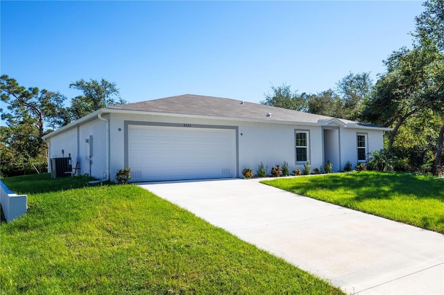 single story home with a front lawn, a garage, and cooling unit