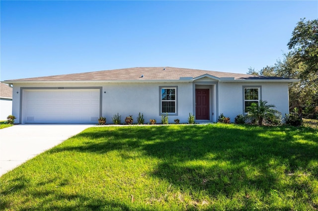 ranch-style house with a garage and a front yard