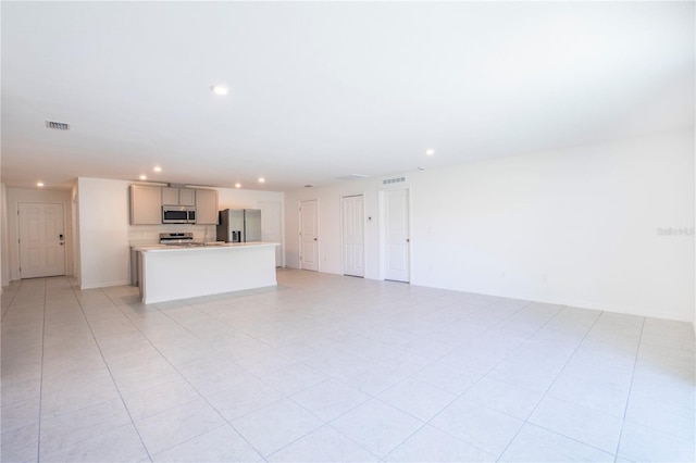 unfurnished living room with light tile patterned floors