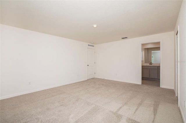 carpeted spare room featuring sink