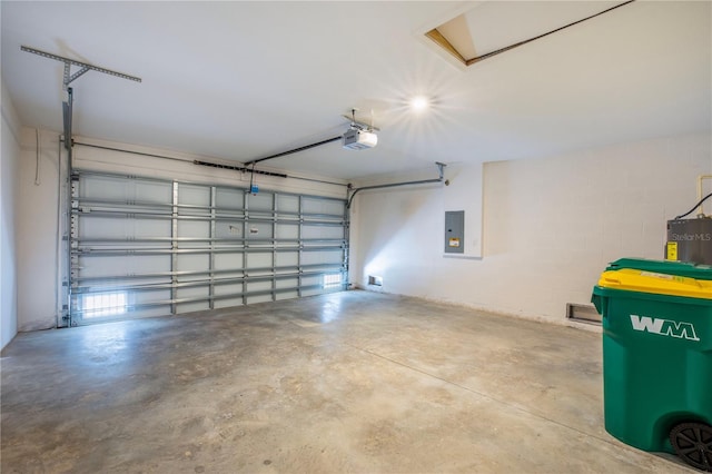 garage featuring electric panel, electric water heater, and a garage door opener