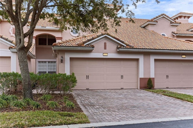 mediterranean / spanish house featuring a garage