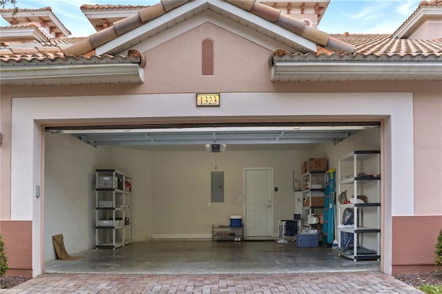 garage with electric panel and a garage door opener