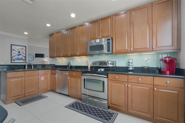 kitchen featuring stainless steel appliances, light tile floors, tasteful backsplash, ornamental molding, and sink