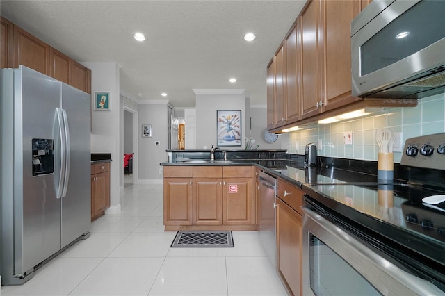 kitchen featuring light tile floors, crown molding, appliances with stainless steel finishes, dark stone countertops, and backsplash