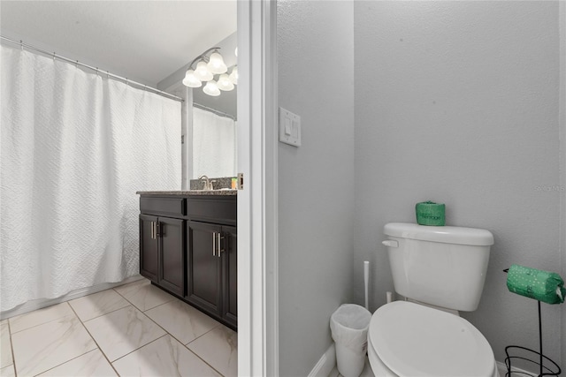 bathroom with vanity, a shower with shower curtain, and toilet