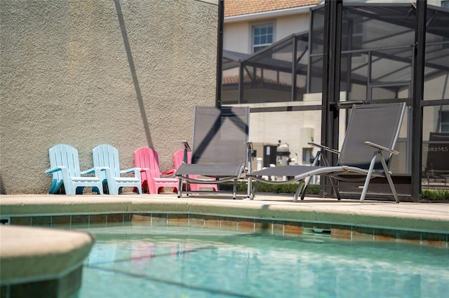 view of pool with glass enclosure