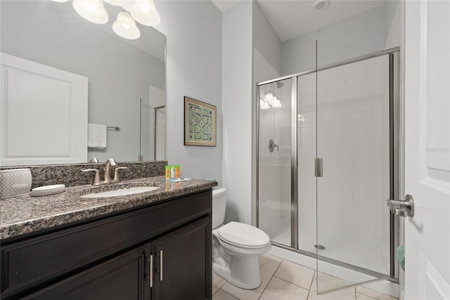 bathroom featuring toilet, walk in shower, vanity, and tile patterned floors