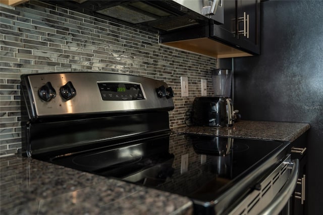 kitchen with electric range and backsplash