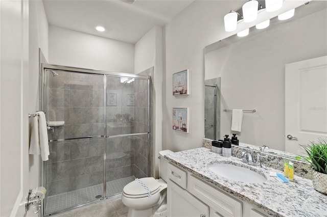 bathroom featuring tile floors, toilet, walk in shower, and vanity