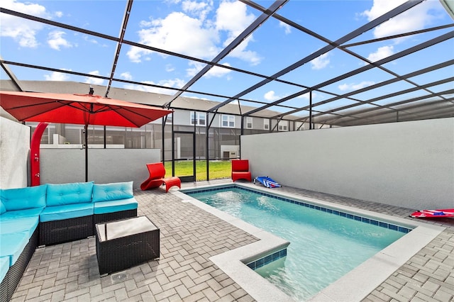 view of pool with outdoor lounge area, a patio area, and a lanai