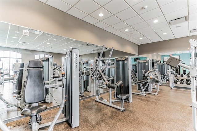 gym with a paneled ceiling