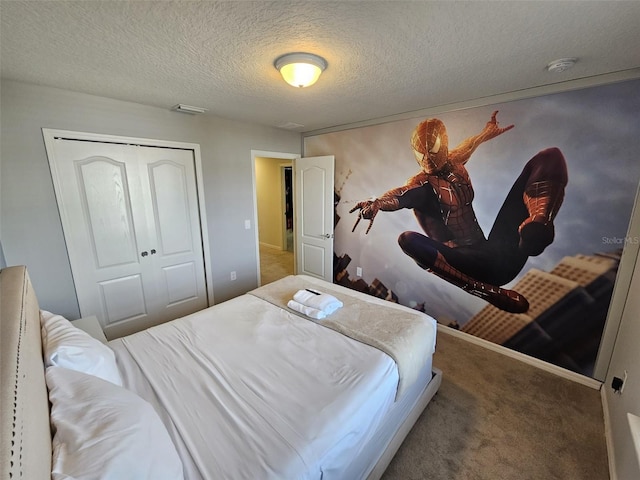 carpeted bedroom featuring a closet and a textured ceiling