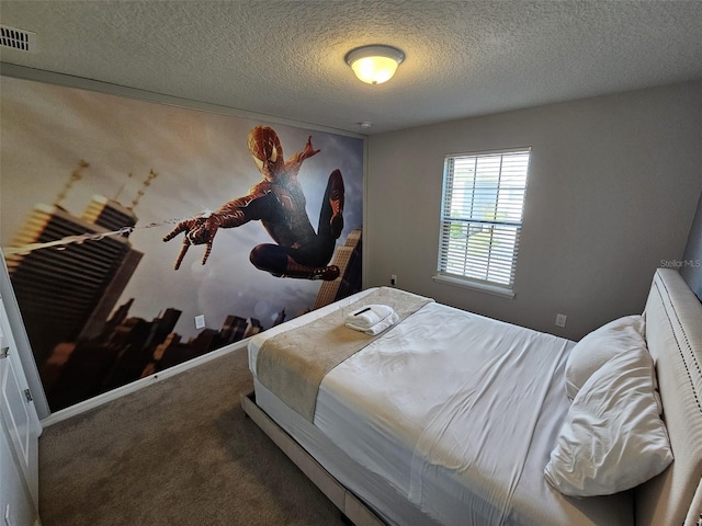 bedroom with carpet floors and a textured ceiling