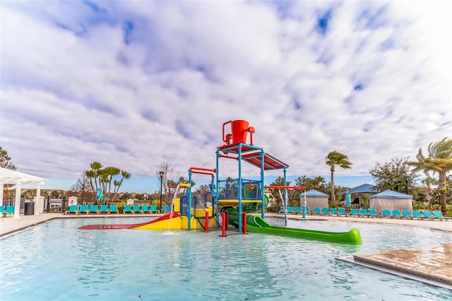 view of jungle gym featuring a community pool