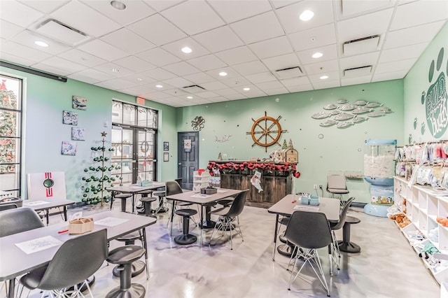 recreation room featuring a drop ceiling