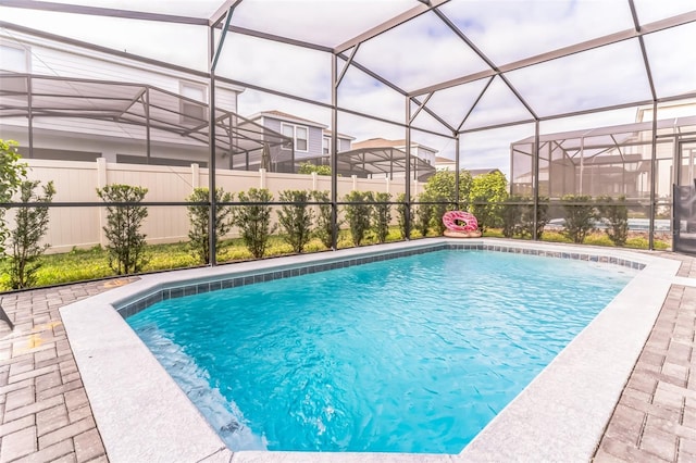 view of pool with a patio area and a lanai