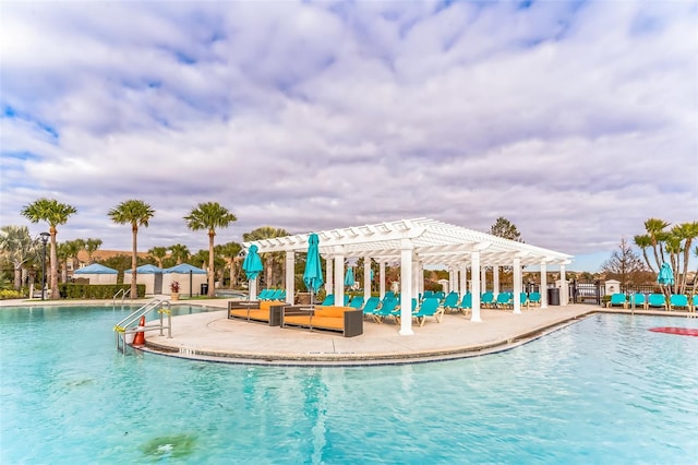 view of swimming pool featuring a patio area and a pergola