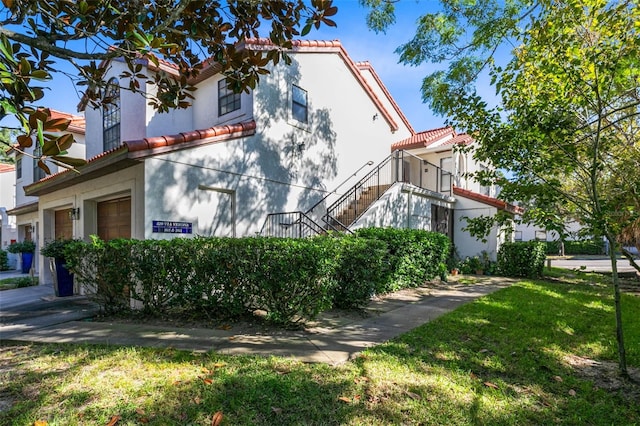 view of home's exterior featuring a lawn and a garage