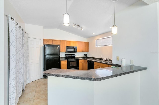 kitchen with kitchen peninsula, black appliances, light tile floors, rail lighting, and vaulted ceiling