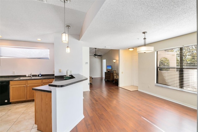 kitchen with plenty of natural light, light tile floors, black dishwasher, and ceiling fan