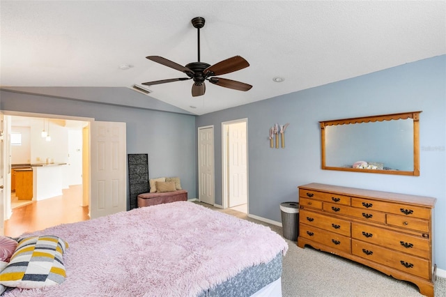 bedroom with light colored carpet, ceiling fan, and lofted ceiling