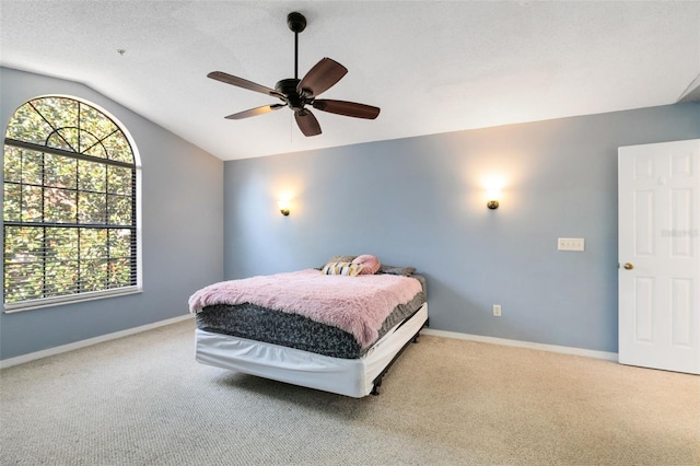 carpeted bedroom with lofted ceiling and ceiling fan