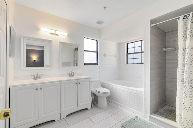 bathroom featuring tile floors, double vanity, toilet, and a healthy amount of sunlight