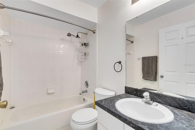 full bathroom with toilet, vanity, and tiled shower / bath