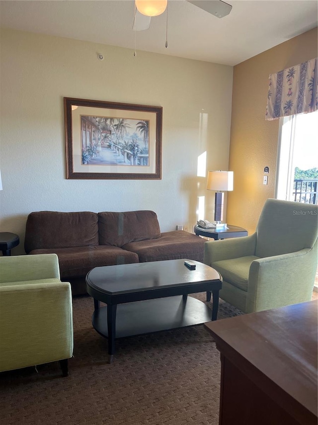 carpeted living room with ceiling fan